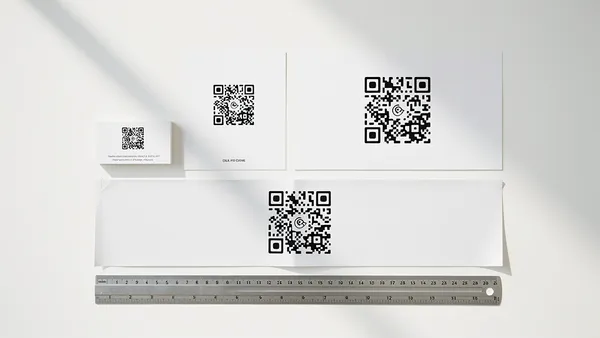 Various printed materials showing correct QR code sizes from business card to poster