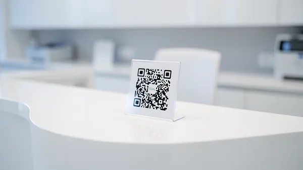 Medical clinic reception with QR code sign for patient check-in